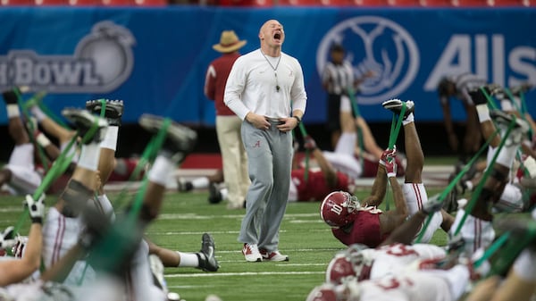 Scott Cochran (center) — pictured working with players as Alabama's director of strength and conditioning before the Peach Bowl in 2016  — won several national championships and SEC titles with the Crimson Tide. (Vasha Hunt/AP)
