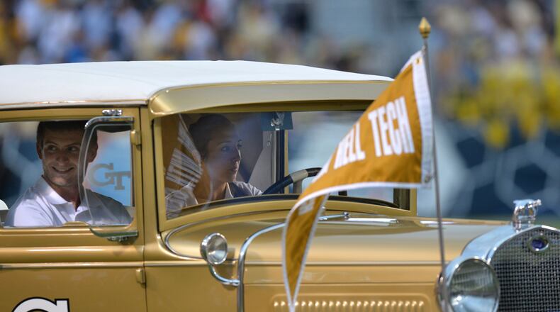 Georgia Tech’s Ramblin’ Wreck driver Hillary Degenkolb (right) drives on the field after the pregame ceremony before the start of the Georgia Tech season opener against the Alcorn State Braves in Bobby Dodd Stadium on Thursday, September 3, 2015. HYOSUB SHIN / HSHIN@AJC.COM