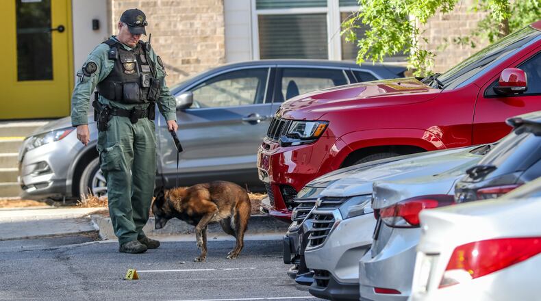 May 10, 2022 Atlanta: An Atlanta police K-9 unit works the scene at the Skylark apartment complex on Boulevard after a shooting and car break-ins. Investigators are working to learn what happened before a gunshot victim ended up dead Tuesday morning, May 10, 2022 at a southeast Atlanta apartment complex. (John Spink / John.Spink@ajc.com)
