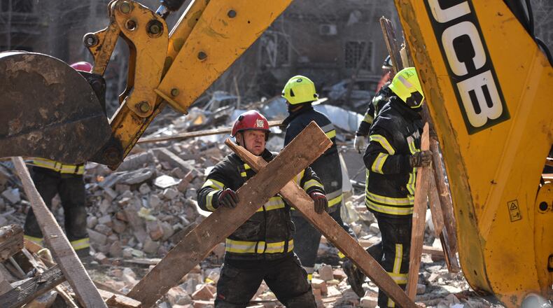 A rescue worker clears the rubble after a Russian strike on residential neighbourhood of Dnipro, Ukraine, Saturday, April 25, 2026. (AP Photo/Mykola Synelnykov)
