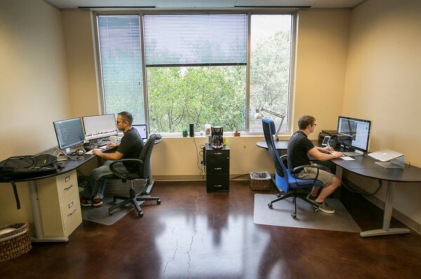 Parag Patel, left, and Jared King, right, are co-founders of Invoiced, their bootstrap startup created with little money or overhead. The partners work out of leased offices within a medical business in southwest Austin.
RALPH BARRERA/AMERICAN-STATESMAN