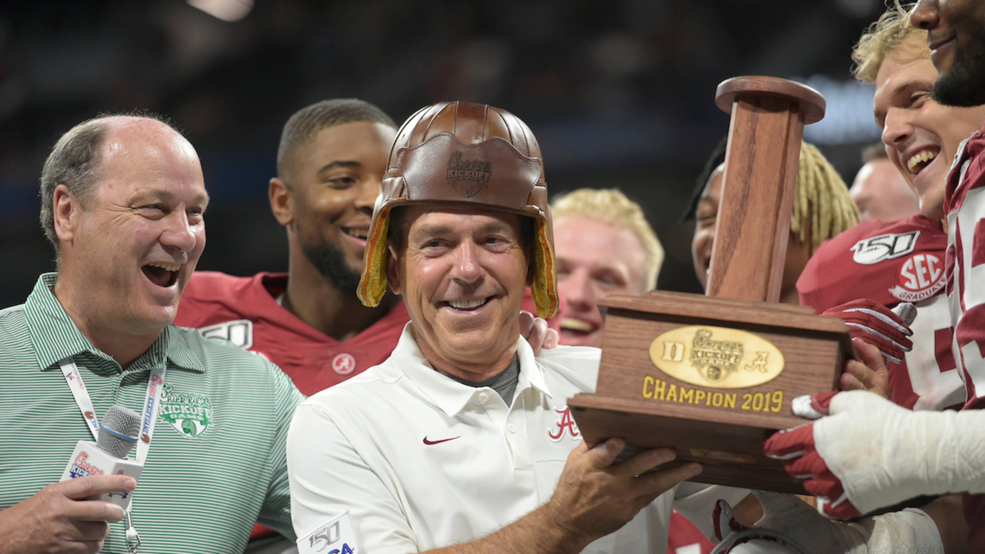 Peach Bowl president and CEO Gary Stokan (left, in green shirt), pictured here with the Alabama Crimson Tide team after it won its Chick-fil-A Kickoff game over Duke at Mercedes-Benz Stadium in 2019, will retire in May 2026, he told The Atlanta Journal-Constitution Monday. It will end a 28-year tenure leading the Peach Bowl, which also operates the kickoff game. (Vasha Hunt via Abell Images for Chick-fil-A Kickoff)
