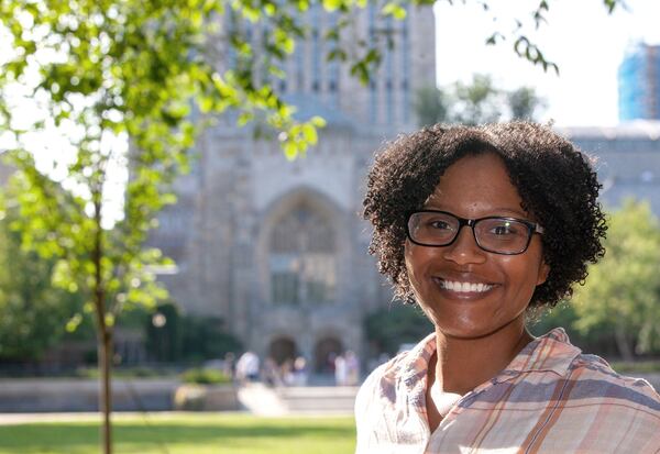 Chelesa Fearce, a Clayton County student who overcame homelessness to become her high school class valedictorian in 2013, stands in front of the Sterling Memorial Library at Yale University. She is working on her doctorate and a medical degree at the Yale School of Medicine. (Michelle McLoughlin for The Atlanta Journal-Constitution)
