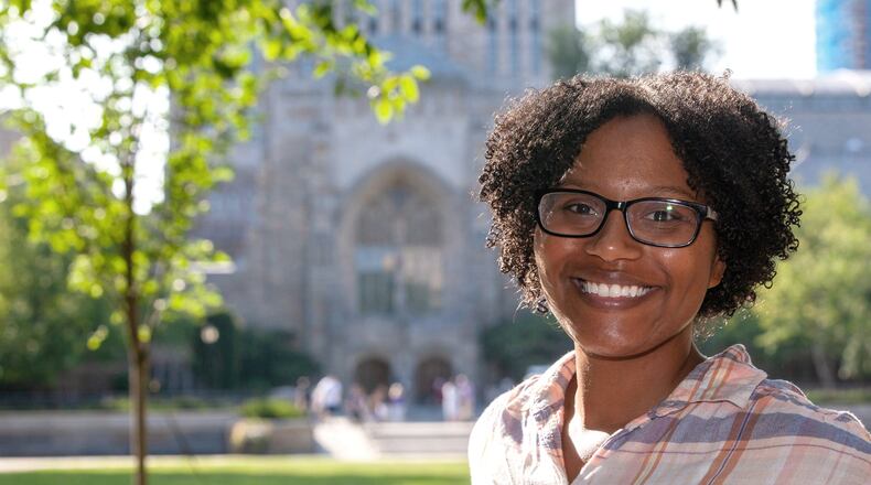 Chelesa Fearce, a Clayton County student who overcame homelessness to become her high school class valedictorian in 2013, stands in front of the Sterling Memorial Library at Yale University. She is working on her doctorate and a medical degree at the Yale School of Medicine. MICHELLE MCLOUGHLIN / FOR THE ATLANTA JOURNAL-CONSTITUTION