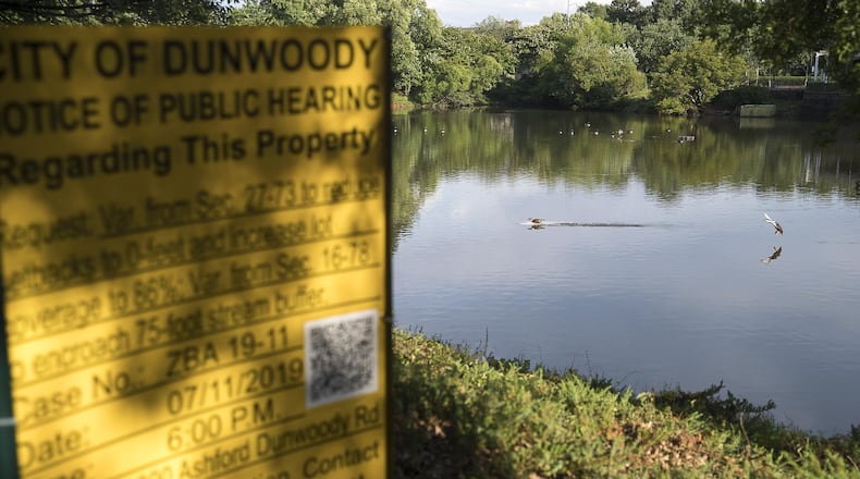 Ducks and geese swim in a pond in Dunwoody, Monday, June, 10, 2019. Developers plan to pave over the pond and building a shopping center. (Alyssa Pointer/alyssa.pointer@ajc.com)