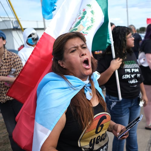 People protest where local authorities say a U.S. Immigration and Customs Enforcement officer (ICE) shot and wounded a man in Austin, Texas, Sunday, Sept. 20, 2026. (AP Photo/Joel Angel Juarez)