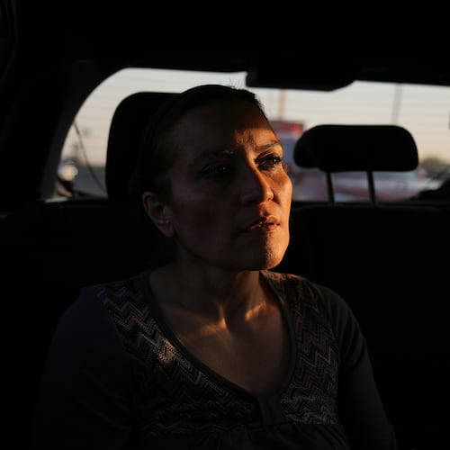 Ninfa Fuentes enters the back seat of a taxi organized by AmorrAs, a feminist transportation collective that offers rides to women who prefer alternatives to public transit due to safety concerns, in Mexico City, Thursday, Nov. 6, 2025. (AP Photo/Claudia Rosel)
