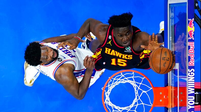 Atlanta Hawks' Clint Capela, right, goes up for a shot against Philadelphia 76ers' Joel Embiid during the second half of an NBA basketball game, Saturday, Nov. 12, 2022, in Philadelphia. (AP Photo/Matt Slocum)