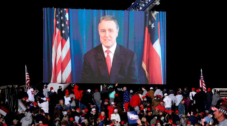 Republican incumbent Sen. David Perdue speaks via video monitor during a rally ahead of a Senate runoff in Dalton, Georgia on Monday, Jan. 4, 2021. (Sandy Huffaker/AFP/Getty Images/TNS)