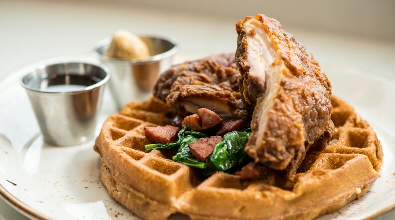 Luda’s Chicken and Pecan Waffles is served with whiskey maple syrup, spinach and andouille sausage. CONTRIBUTED BY MIA YAKEL