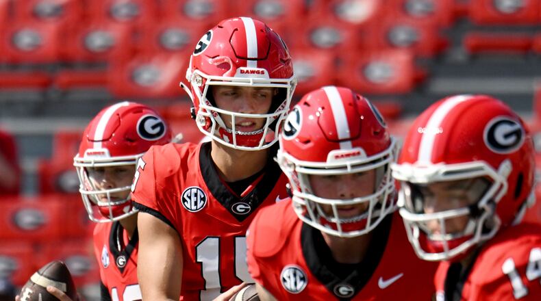 Georgia's quarterback Carson Beck (15) and other quarterbacks warm up during pregame workout before their game against Ball State in an NCAA football game at Sanford Stadium, Saturday, September 9, 2023, in Athens. (Hyosub Shin / Hyosub.Shin@ajc.com)