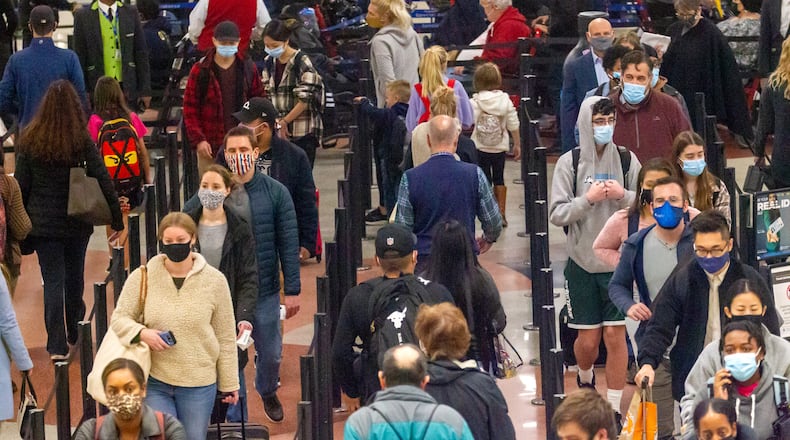 Travelers go through security at Hartsfield-Jackson Atlanta International Airport Sunday, November 21, 2021. STEVE SCHAEFER FOR THE ATLANTA JOURNAL-CONSTITUTION