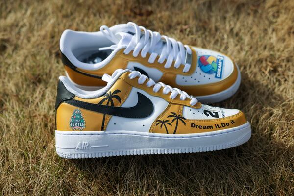 A detail of the sneakers designed for cancer survivor Burke Bowie by Curtis Booth of Elite Feet Customs. It has turtle emblems and playoff colors. (Jason Getz/AJC)