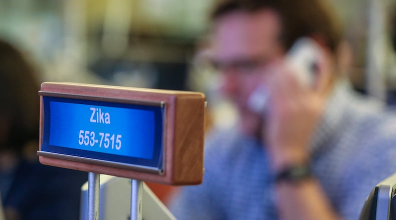 John Brook, medical epidemiologist works the phone at his Zika station in the emergency operations center on Wednesday. JOHN SPINK /JSPINK@AJC.COM