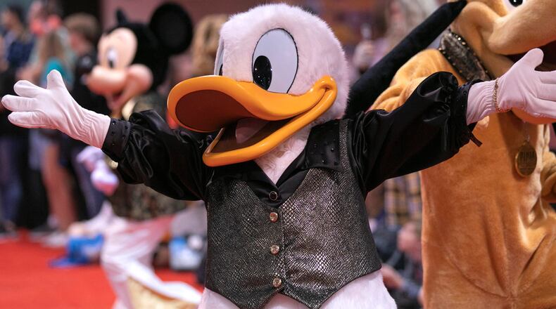 FILE PHOTO: A service dog recently melted the heart of a costumed performer portraying Donald Duck.
