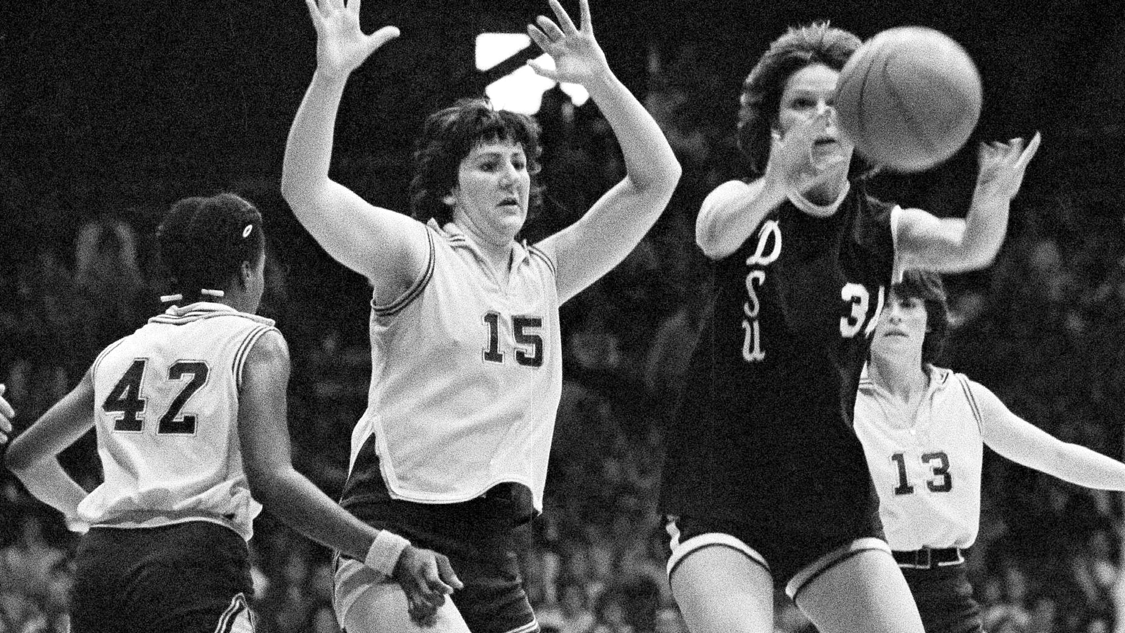 FILE - Louisiana State's Maree Bennie (15) throws up her arms in defense as Delta State's Wanda Hairston of Delta State passes the ball during the finals of the AIAW national basketball championships in Minneapolis, Minn., March 28, 1977. (AP Photo/Jim Mone, File)