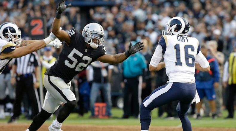 This Aug. 19, 2017, file photo shows Oakland Raiders defensive end Khalil Mack (52) sacking Los Angeles Rams quarterback Jared Goff (16) during the first half of an NFL preseason football game in Oakland.  (AP Photo/Rich Pedroncelli, File)
