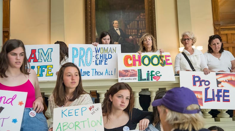 03/22/2019 -- Atlanta, Georgia -- Pro-Choice and Pro-Life demonstrators display their signs during the 35th legislative day at the Georgia State Capitol building in downtown Atlanta, Friday, March 22, 2019. The Georgia Senate is set for a lengthy debate on the anti-abortion "heartbeat bill" Friday. Sen. Renee Unterman is carrying the bill for Rep. Ed Setzler.  (ALYSSA POINTER/ALYSSA.POINTER@AJC.COM)