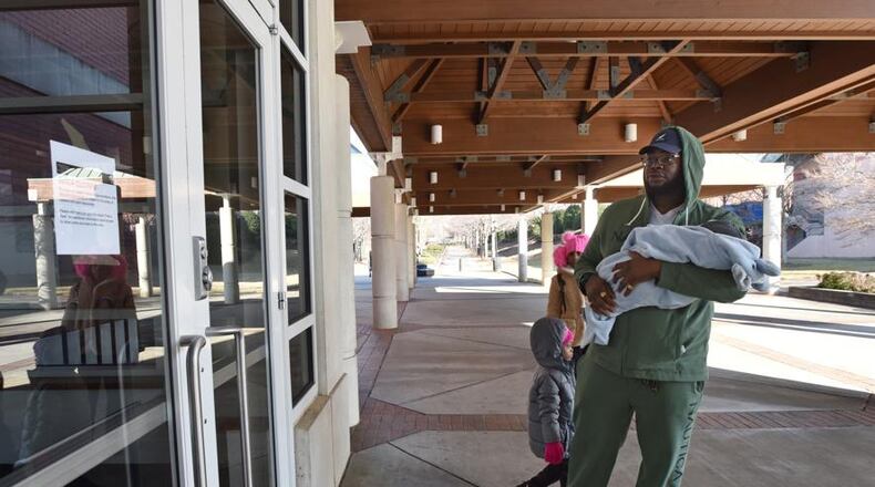 Javaris Green Sr., of St. Petersburg, Fla., holding his 3 months-old son Javaris Green Jr., can't hide his disappointment as he finds out Martin Luther King Jr. National Historical Park site is closed due to a government shutdown on Saturday, Dec. 22, 2018. (Photo: HYOSUB SHIN / HSHIN@AJC.COM)