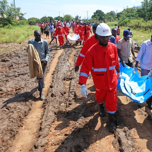 Rescue teams carry bodies of victims of a landslide in the hilly area of Chesongoch in Elgeyo Marakwet county, western Kenya, Sunday, Nov. 2, 2025. (AP Photo/Andrew Kasuku)