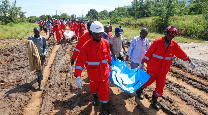 Rescue teams carry bodies of victims of a landslide in the hilly area of Chesongoch in Elgeyo Marakwet county, western Kenya, Sunday, Nov. 2, 2025. (AP Photo/Andrew Kasuku)