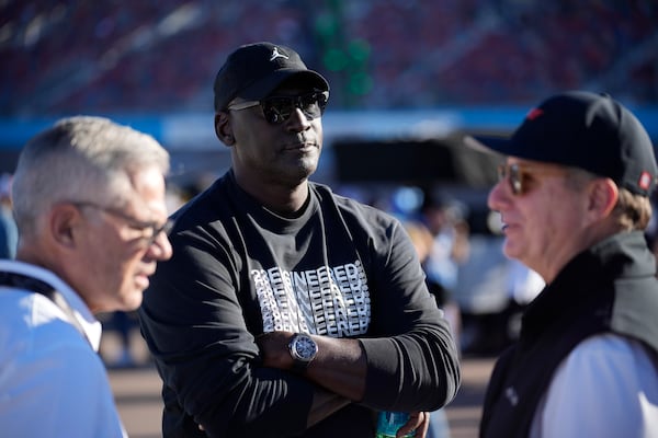 FILE - Michael Jordan, center, and Curtis Polk, left, co-owners of 23XI Racing, watch during qualifying beside 23XI Racing President Steve Lauletta, right, for a NASCAR Cup Series Championship auto race, Nov. 9, 2024, in Avondale, Ariz. (AP Photo/John Locher, file)