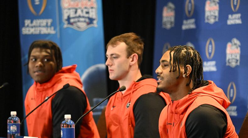 Bulldogs lineman Broderick Jones (from left), tight end Brock Bowers and running back Kenny McIntosh answer questions from members of the media during Georgia's news conference Wednesday in Atlanta. (Hyosub Shin / Hyosub.Shin@ajc.com)