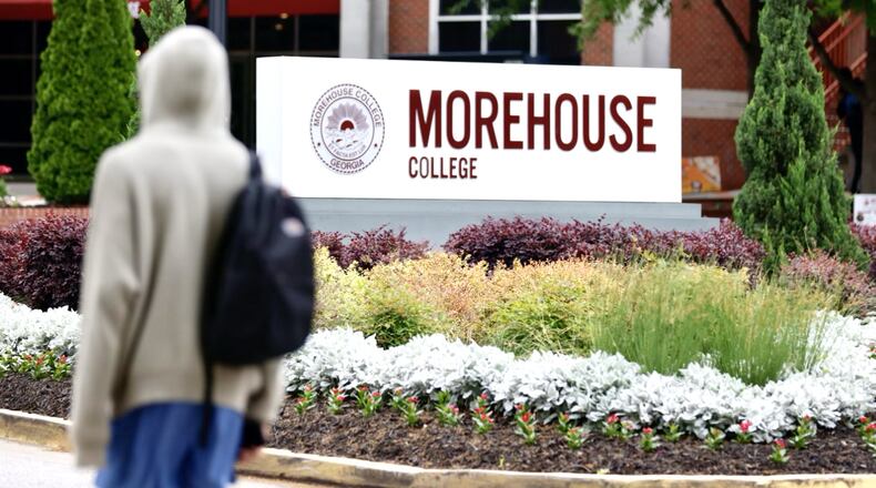 A student walks by a Morehouse College sign in Atlanta on April 24, 2024. (Miguel Martinez/AJC)