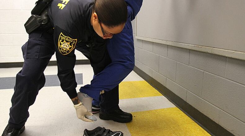 Deputy P. Brown performs a search at the Gwinnett County Jail, which participates in the federal 287(g) immigration enforcement program.