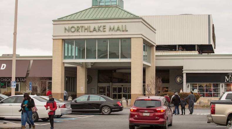 Pedestrians mill through the parking lot of Northlake Mall in DeKalb County.