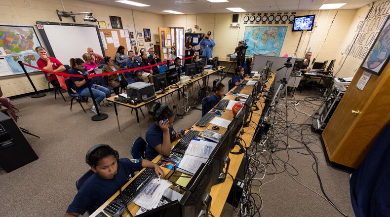 Students from Russell Elementary’s Space Team tackle launching a space shuttle from Mission Control inside the Smyrna school. Contributed.