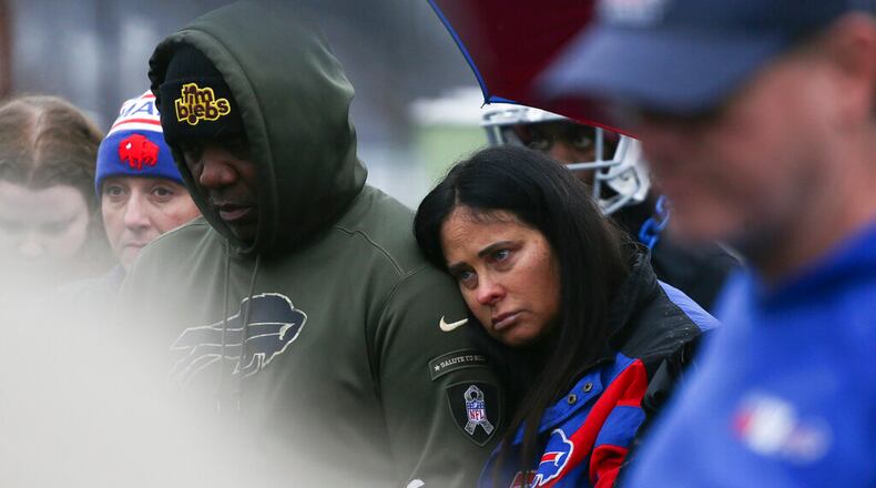 Thurman Thomas, left, and Patti Thomas, right, listen during a prayer circle for Buffalo Bills' Damar Hamlin on Tuesday, Jan. 3, 2023, in Orchard Park, N.Y. The family of Damar Hamlin expressed gratitude for the outpouring of support shown toward the Buffalo Bills safety who suffered cardiac arrest after making a tackle while asking everyone to keep the hospitalized player in their prayers on Tuesday.(AP Photo/Joshua Bessex)