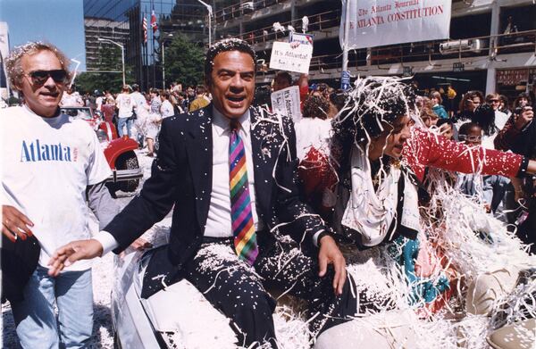 Mayor Andrew Young with his wife in Atlanta's celebratory parade for the winning Olympics bid, 1990. (Marlene Karas/AJC 1990)