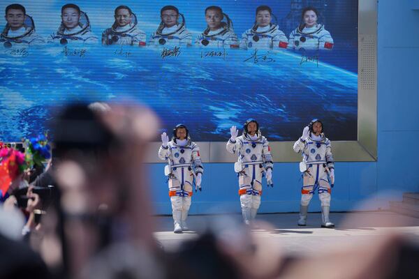 Chinese astronauts for the Shenzhou 20 mission, from right, Chen Zhongrui, Chen Dong and Wang Jie wave as they attend a send-off ceremony for their manned space mission at the Jiuquan Satellite Launch Center in northwestern China, Thursday, April 24, 2025. (AP Photo/Andy Wong)