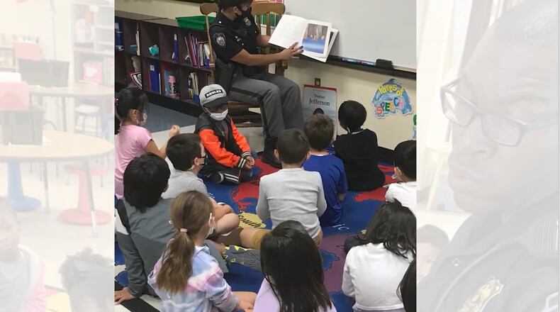 Johns Creek Police Officers visit elementary schools on Wednesdays to read to the students, part of the "Worth it Wednesday" program designed to build trust between students and police. COURTESY JOHNS CREEK POLICE