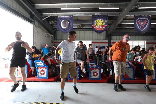 James Fordham (center) gets off ArieForce One after taking a ride. He says he also has had his share of what he calls “Zen rides,” when no one else is aboard. (Arvin Temkar/AJC)