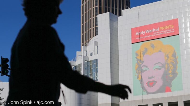 Lauren Dutro strolls pass the High Musuem of Art in Midtown. JOHN SPINK / JSPINK@AJC.COM
