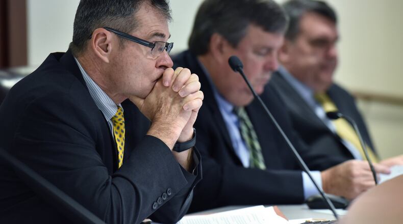 Commissioner Tim Echols (left) listens during Georgia Public Service Commission meeting on Dec. 21, 2017 before the commission voted unanimously to allow continued construction of two nuclear reactors at Georgia Power’s embattled Plant Vogtle, which is billions of dollars over budget and years behind schedule. Hyosub Shin / hshin@ajc.com
