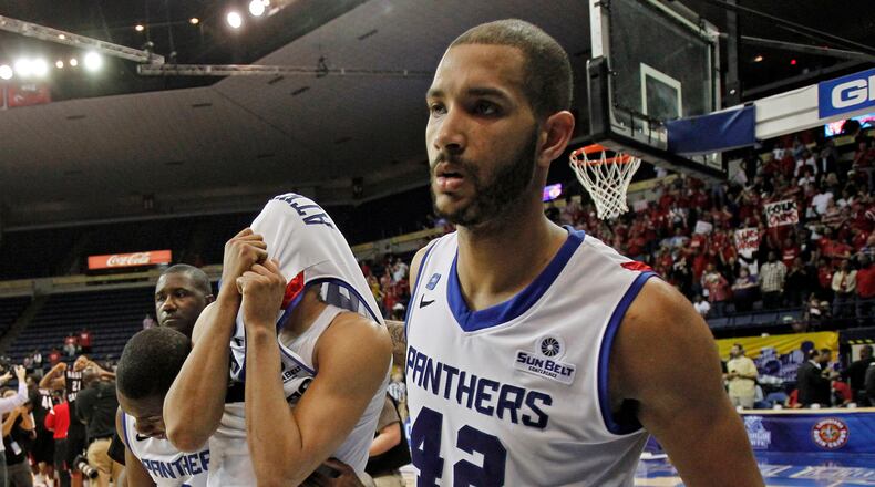 Georgia State forward Curtis Washington (42) and Georgia State guard Ryann Green (2) help Georgia State forward Manny Atkins, center, off the court after they lost to Louisiana Lafayette in an NCAA college basketball game for the Sun Belt Conference tournament championship in New Orleans, Sunday, March 16, 2014. Louisiana Lafayette won 82-81. (AP Photo/Bill Haber)