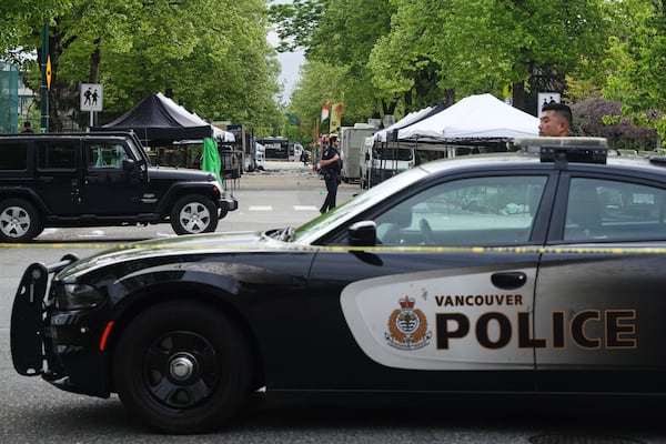 Vancouver Police survey the scene after a driver killed multiple people Saturday during a Filipino community festival Sunday, April 27, 2025, in Vancouver, British Columbia. (AP Photo/Lindsey Wasson)