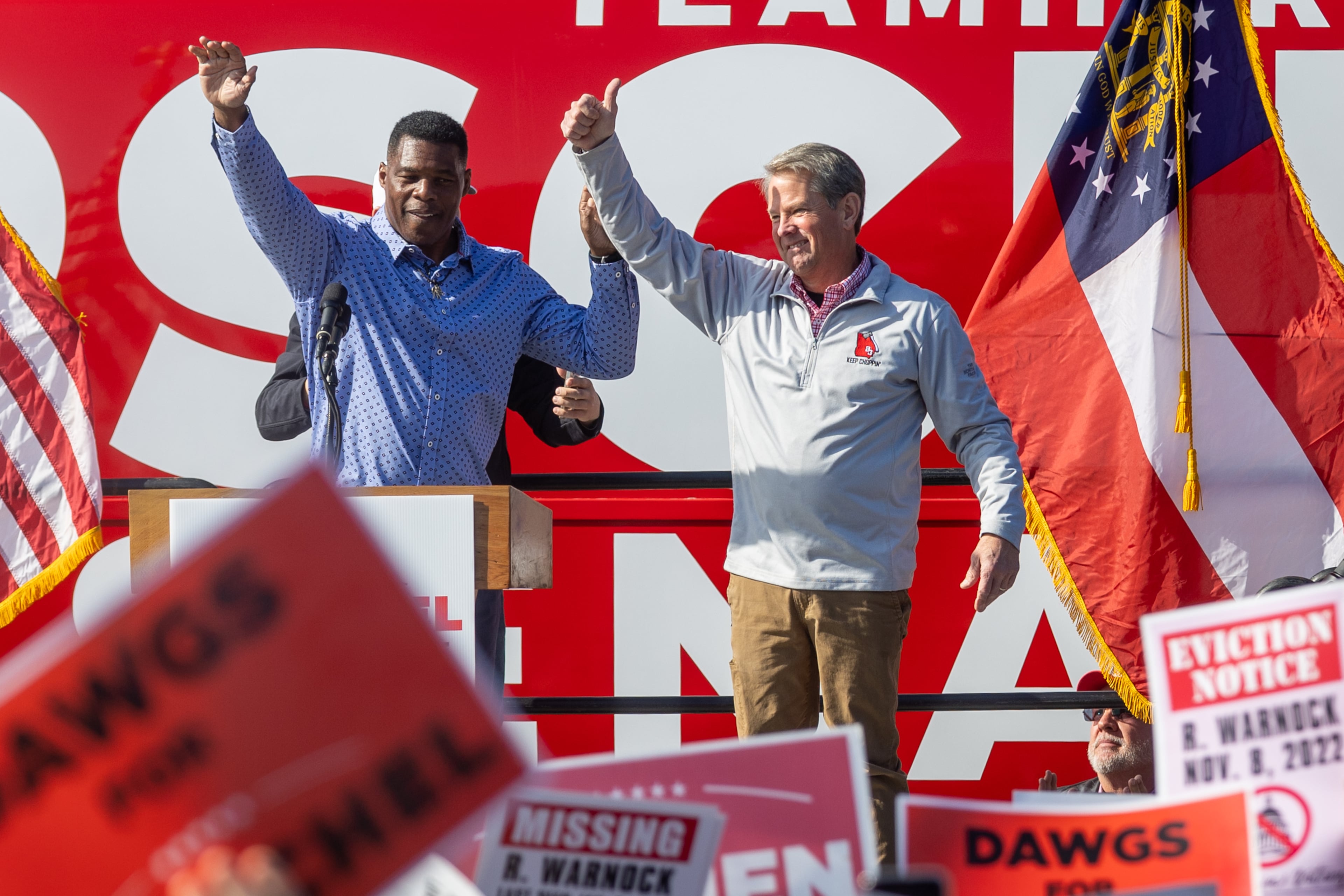 Gov. Brian Kemp (right) and Republican U.S. Senate hopeful Herschel Walker wave to the crowd at the end of a rally in Smyrna Saturday, November 19, 2022. (Steve Schaefer/AJC)