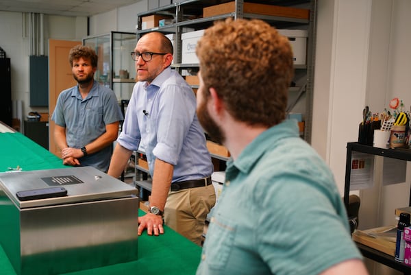 From left, Eric Schweickart, Jack Gary and Evan Bell chat in the Colonial Williamsburg archaeology lab in Williamsburg, Va., on Thursday, May 29, 2025. (AP Photo/Allen G. Breed)