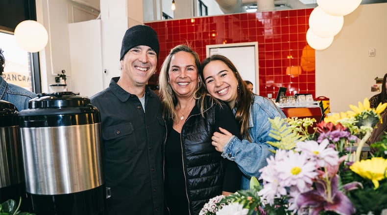 Owner of Warm Waves Coffee Kenny Libby (left) poses with wife Shawn Libby (middle) and daughter Brooke Libby (right) at the grand opening of their newest cafe location.