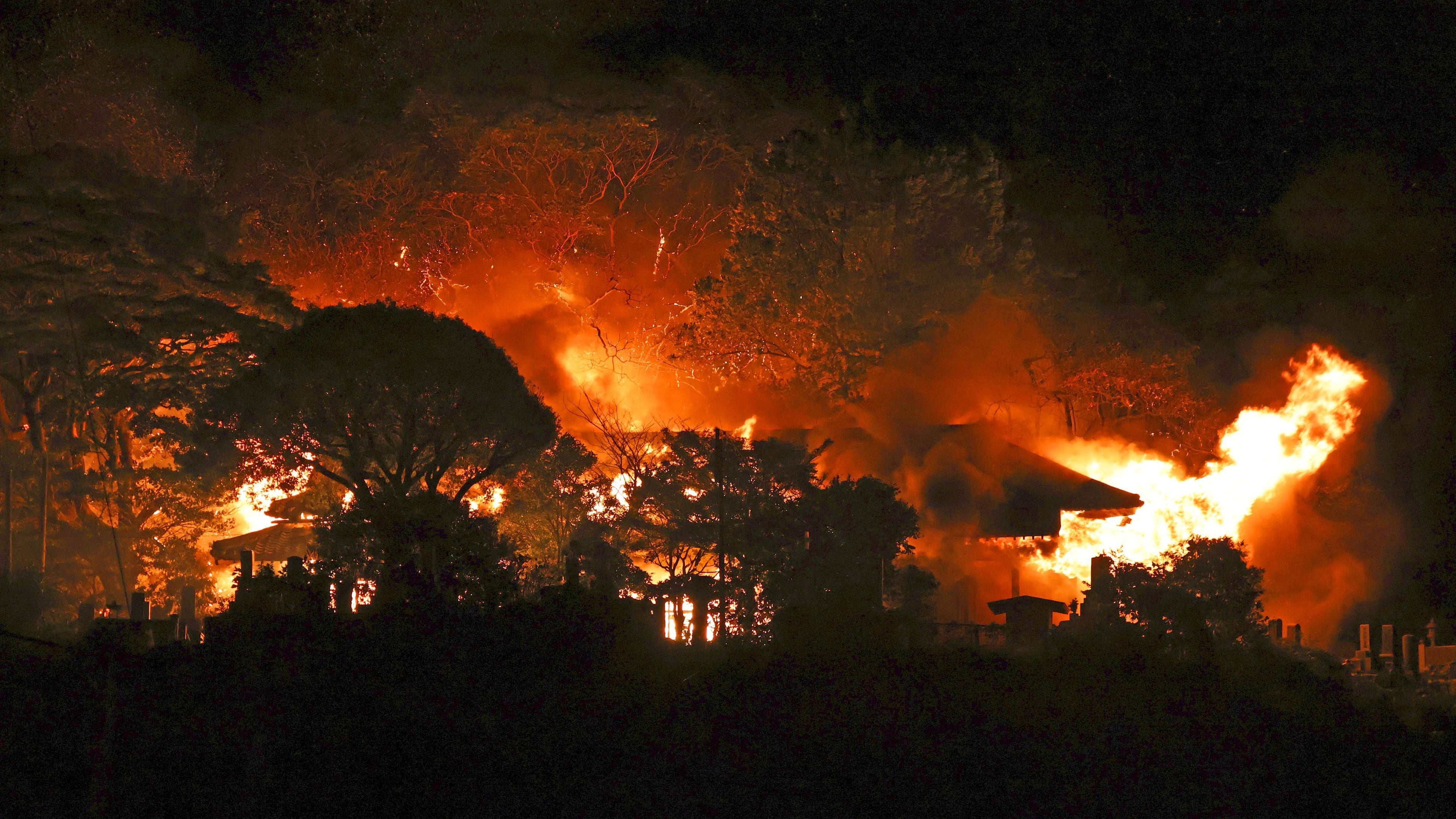 Flames rise from the site of a fire in Oita, southern Japan Tuesday, Nov. 18, 2025. (Kyodo News via AP)