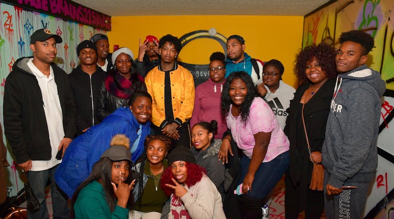 21 Savage poses with 21 Atlanta kids enrolled in his "Bank Account" financial literacy program.