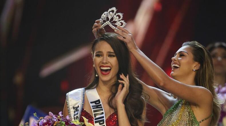 Catriona Gray of the Philippines, left, reacts with joy as she is crowned the Miss Universe 2018 by Miss Universe 2017 Demi-Leigh Nel-Peters during the final round of the 67th Miss Universe competition in Bangkok, Thailand, Monday, Dec. 17, 2018.(AP Photo/Gemunu Amarasinghe)