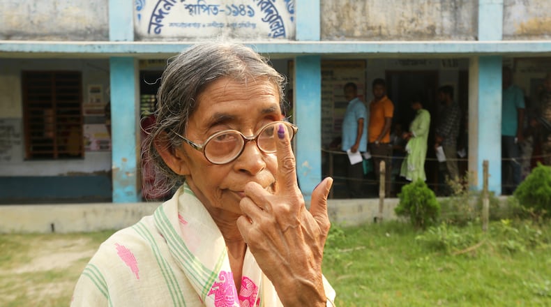 An elderly voter poses for a photograph after casting her vote during the first phase of polling in Nandigram, in West Bengal state, India, Thursday, April 23, 2026. (AP Photo/Bhaskar Mallick)