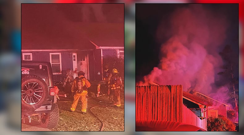 Cobb County firefighters pulled a woman from a burning home on North Hampton Drive near Kennesaw.