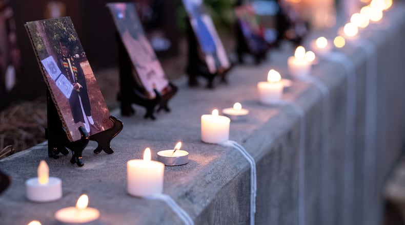 Candles line the wall before a memorial service for Kyle Gregory on July 24. He is one of nearly 5,000 Georgia residents who have died of coronavirus. Photo: Ben Gray for the Atlanta Journal-Constitution