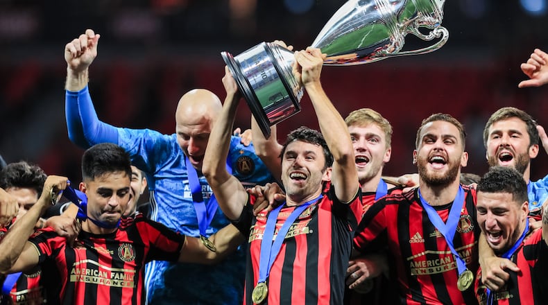 Atlanta United captain Michael Parkhurst raises the U.S. Open Cup trophy after defeating Minnesota United 2-1 in the U.S. Open Cup Final Aug. 27, 2019, at Mercedes-Benz Stadium in Atlanta.